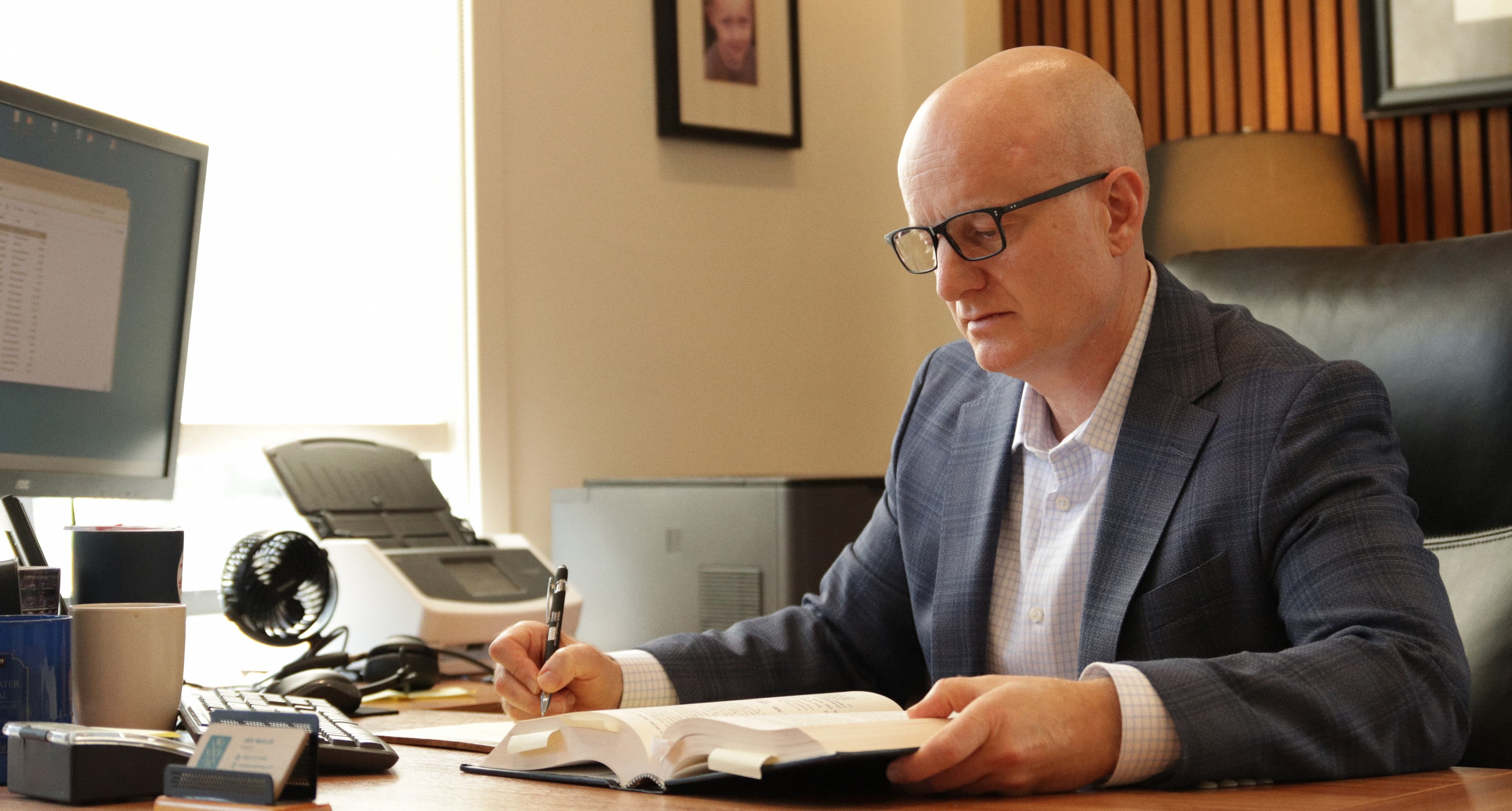 Eric Waxler at his desk, Vames Wang Sosa Hood trial attorneys Oregon personal injury litigation